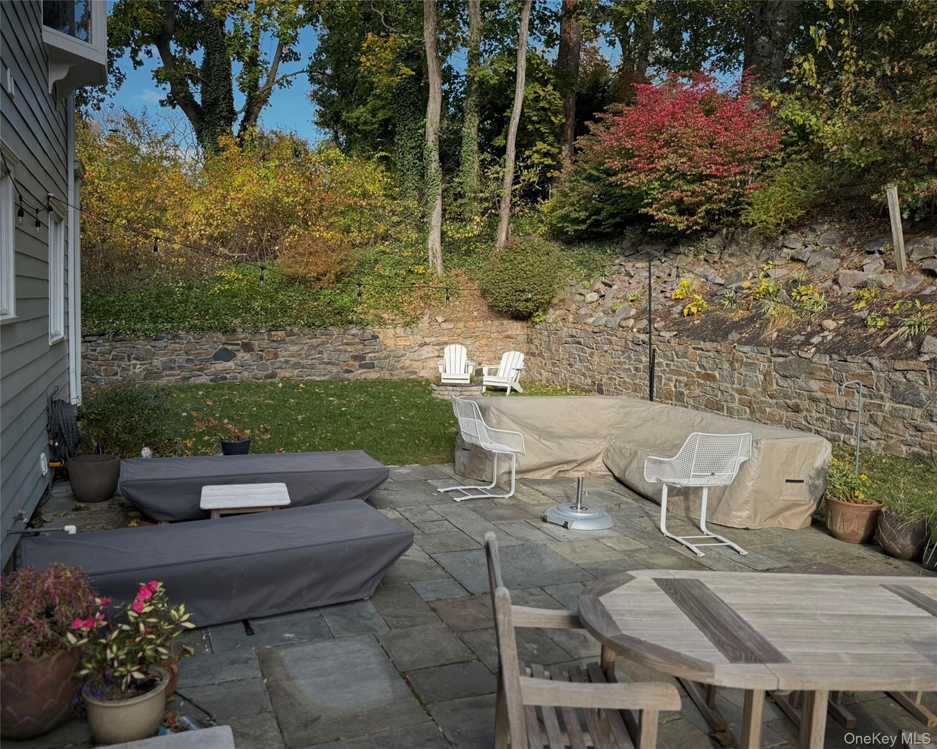 24 Old Well Road Purchase, NY 10577 - Photo 36 of 37 a view of a patio with table and chairs potted plants