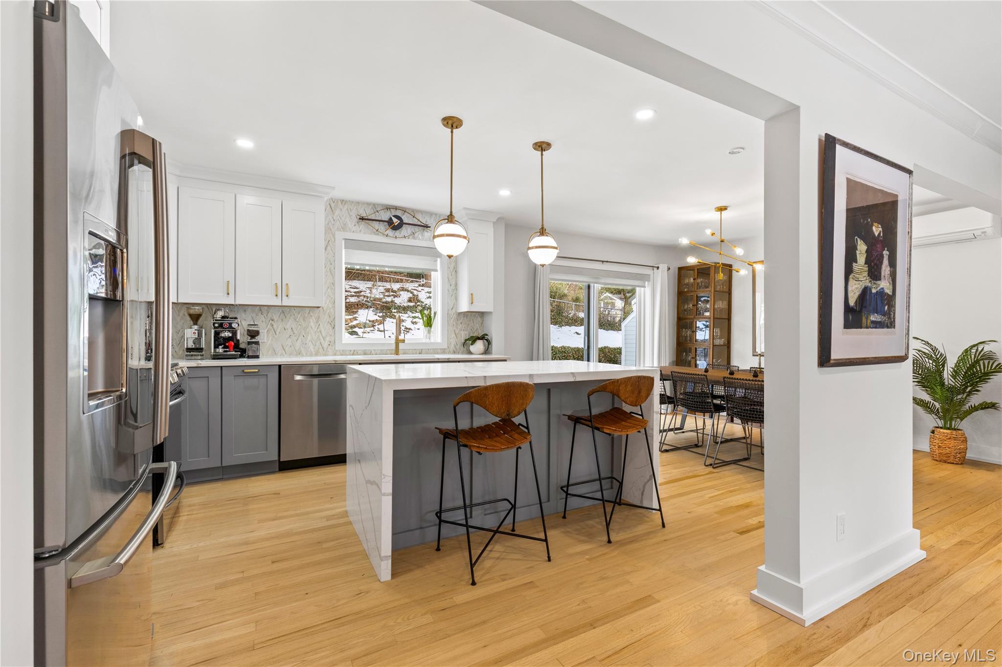 24 Old Well Road Purchase, NY 10577 - Photo 6 of 37 a kitchen with stainless steel appliances granite countertop a refrigerator a sink dishwasher a stove and white countertops with wooden floor
