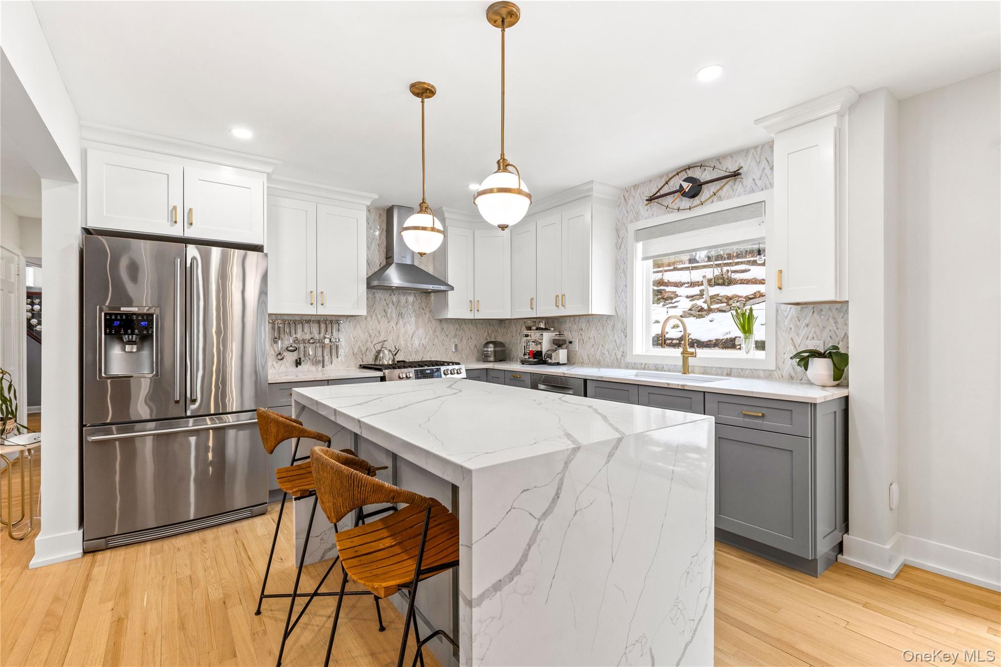 24 Old Well Road Purchase, NY 10577 - Photo 8 of 37 a kitchen with kitchen island a refrigerator a stove a sink and a wooden floor