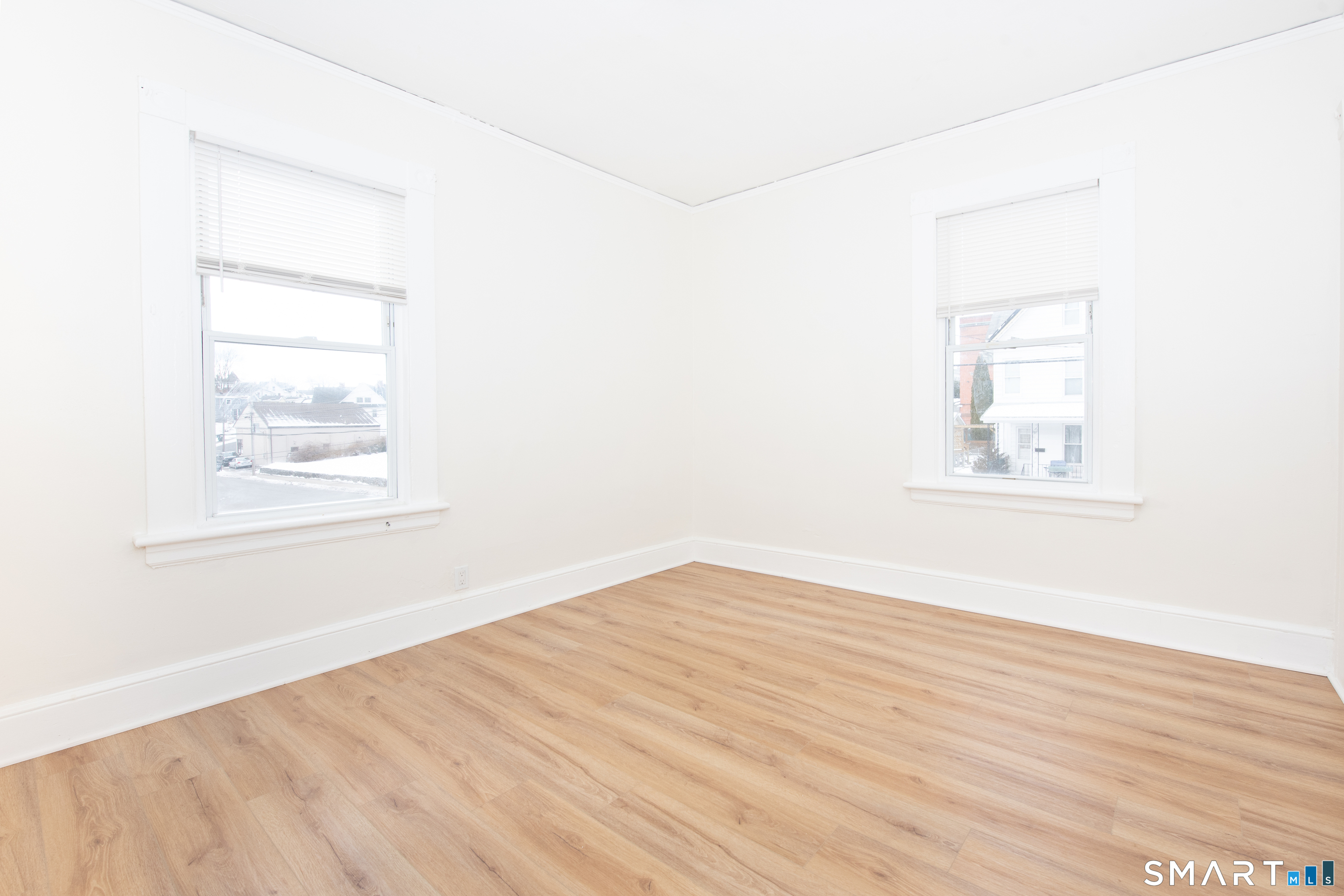 110 Beaver Street Ansonia, CT 06401 - Photo 18 of 30 an empty room with wooden floor and windows