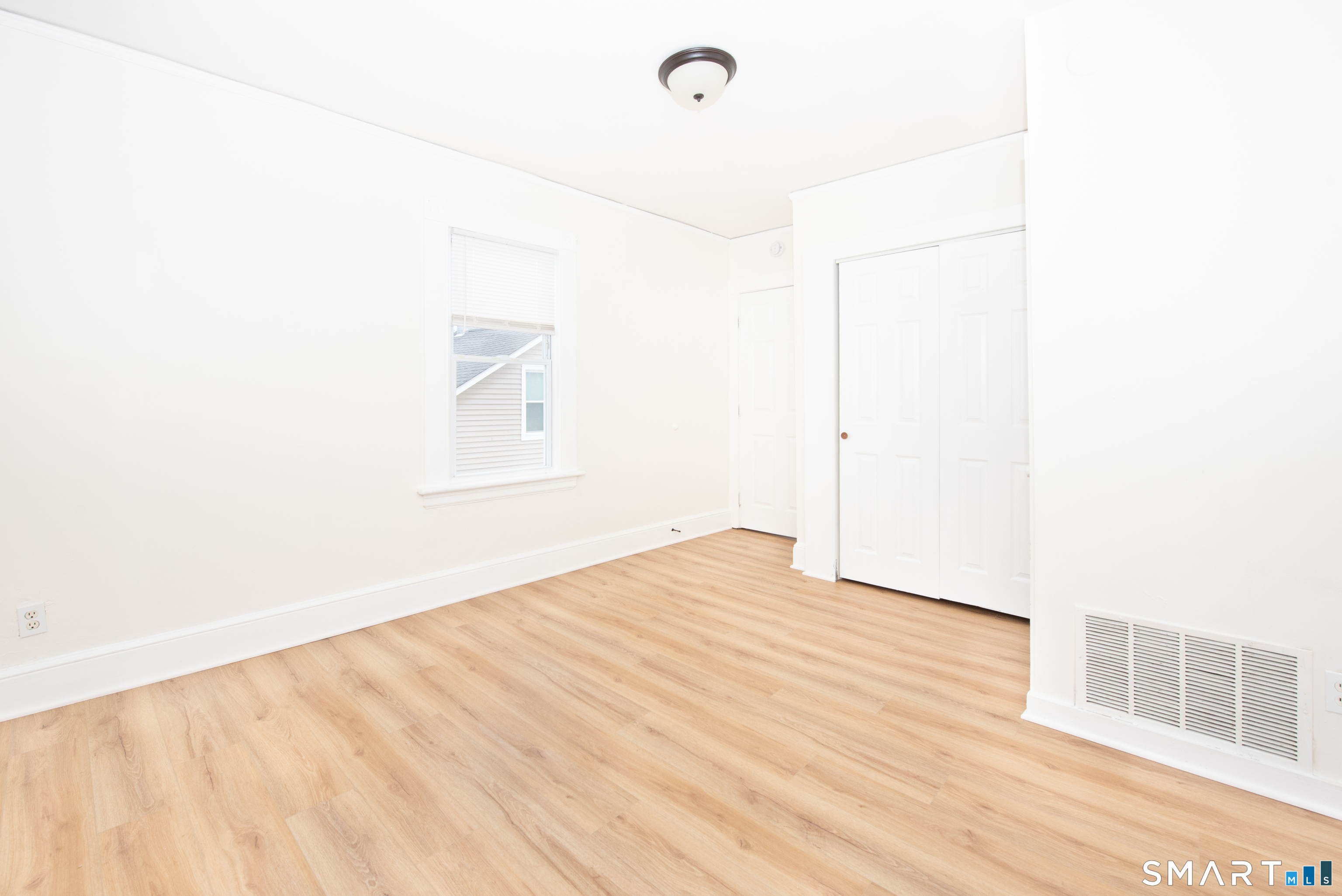 110 Beaver Street Ansonia, CT 06401 - Photo 22 of 30 a view of an empty room with wooden floor