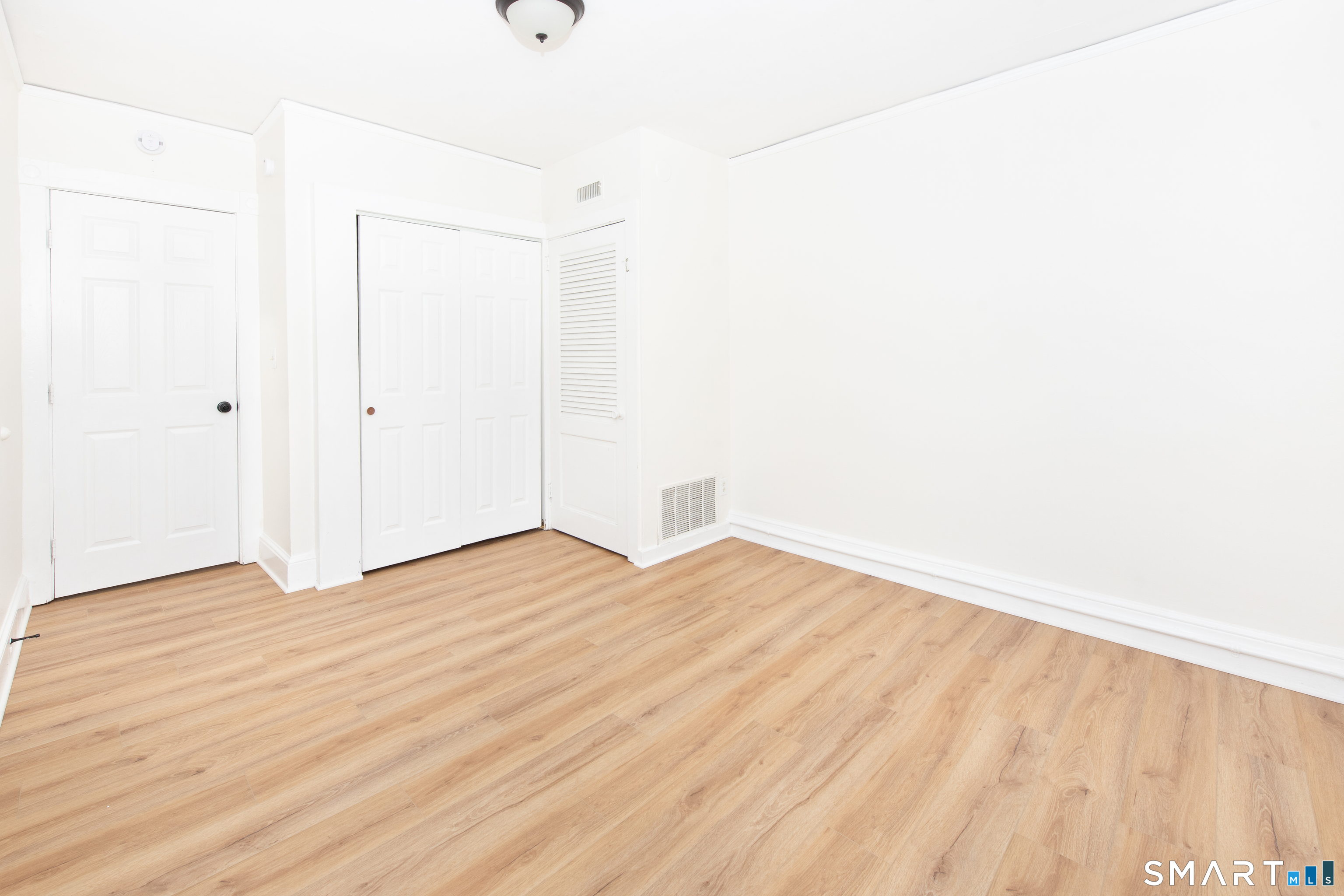 110 Beaver Street Ansonia, CT 06401 - Photo 23 of 30 a view of an empty room with wooden floor