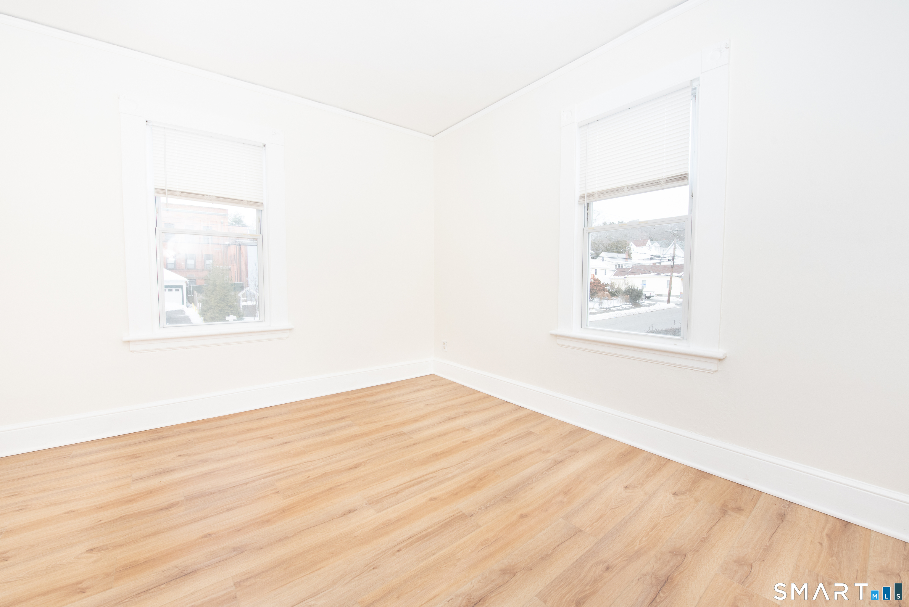 110 Beaver Street Ansonia, CT 06401 - Photo 25 of 30 an empty room with wooden floor and windows