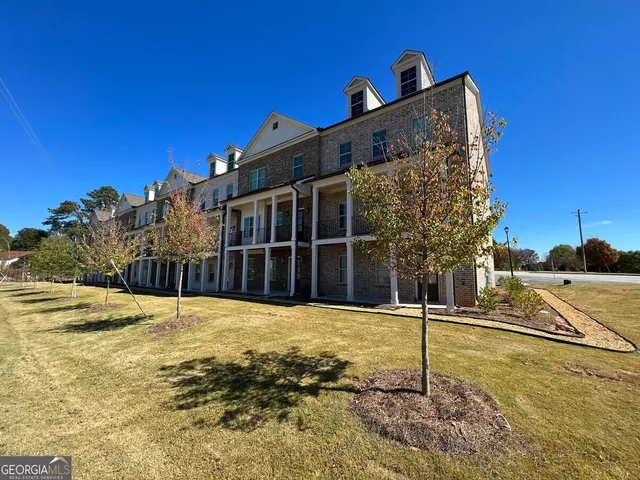a view of a house with snow on the road