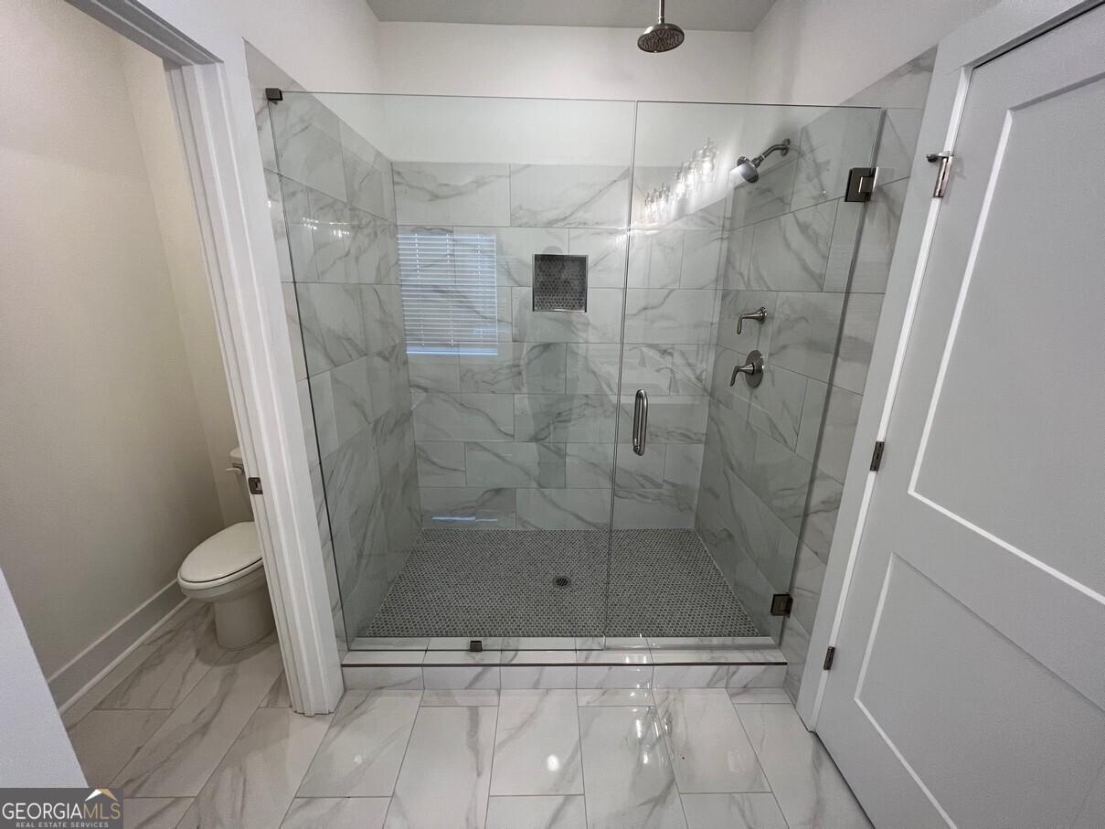 899 Duck Walk Way Lawrenceville, GA 30046 - Photo 29 of 49 a bathroom with a shower and a toilet