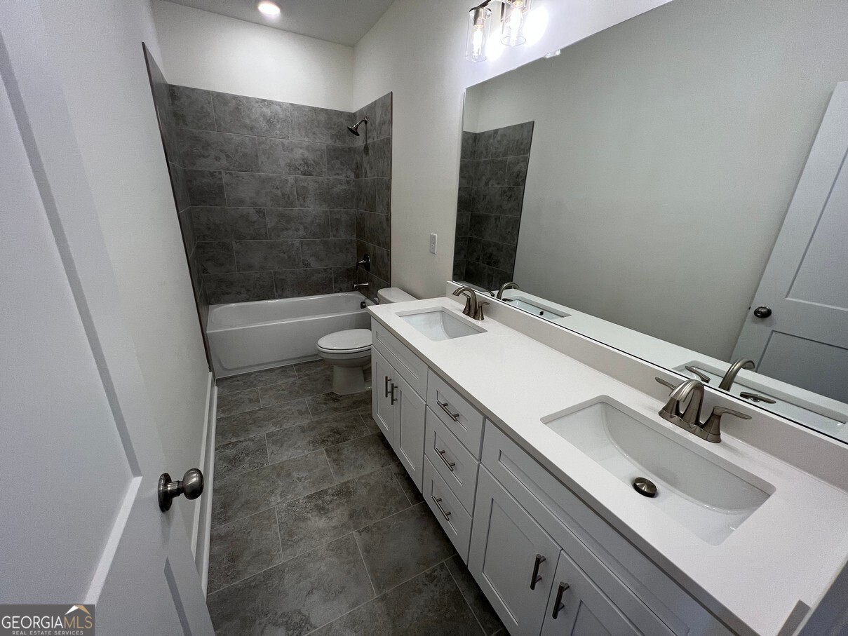899 Duck Walk Way Lawrenceville, GA 30046 - Photo 37 of 49 a bathroom with a double vanity sink mirror double and bathtub