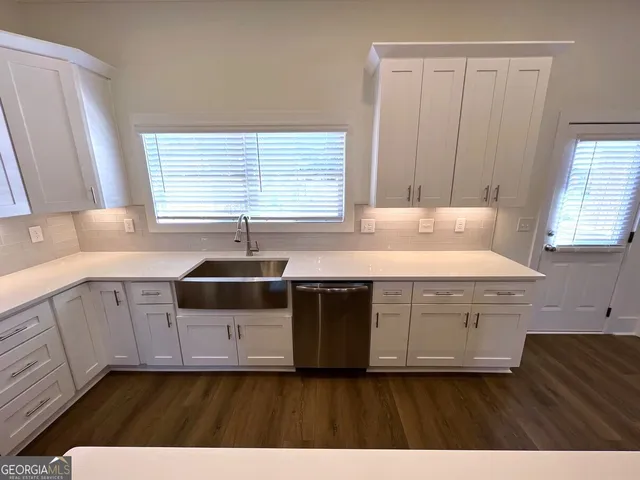 a kitchen with a sink stove and cabinets