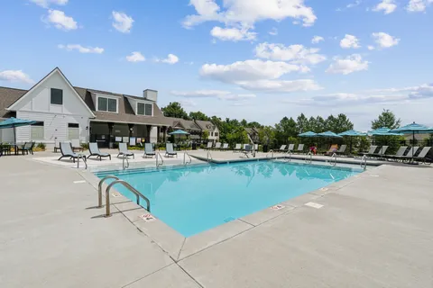 a swimming pool with outdoor view and seating area