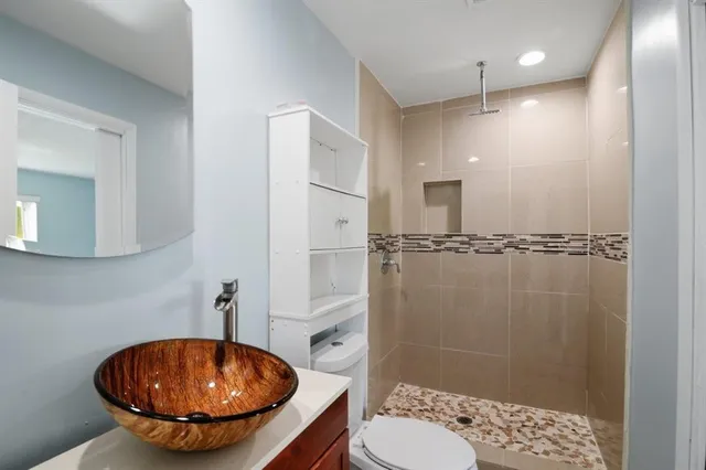 a bathroom with a sink toilet and shower