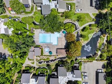 an aerial view of a house with a yard and garden