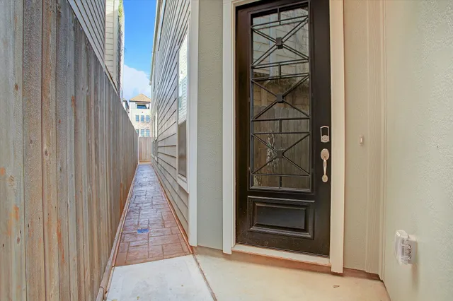 a view of a hallway with wooden floor and entryway