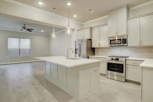 a kitchen with a sink stove and cabinets
