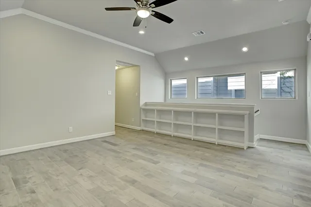 an empty room with a empty space and windows