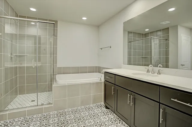 a bathroom with a double vanity sink mirror and shower
