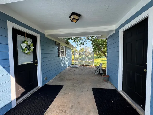 a view of front door and porch with furniture