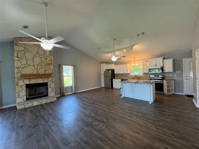 a view of kitchen with a sink and a fireplace