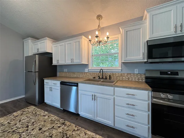 a kitchen with a refrigerator stove and microwave