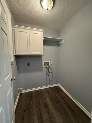 a view of storage and utility room with wooden floor