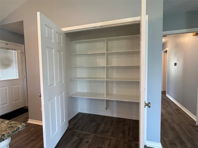 a view of walk in closet with empty racks
