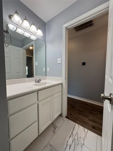 a bathroom with a sink vanity and a mirror