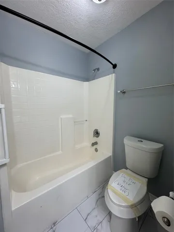 a bathroom with a toilet and a bathtub
