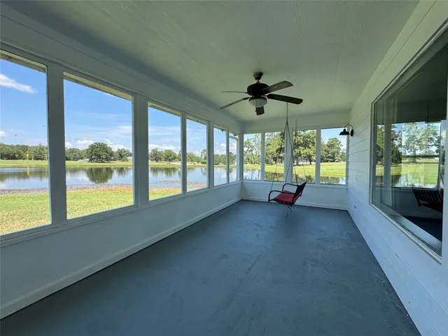 a view of an empty room with a window and a flat screen tv