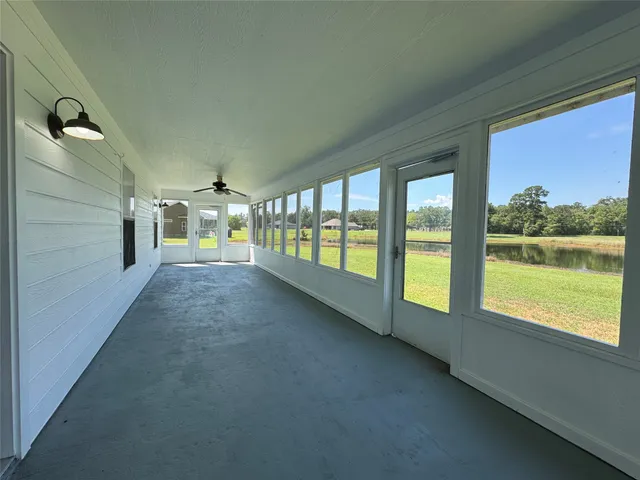 a view of an empty room with a floor to ceiling window and an outdoor view