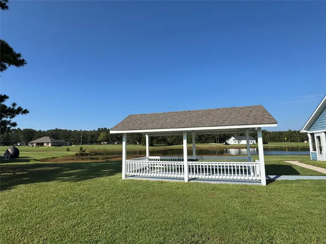 a view of a brick house with a yard