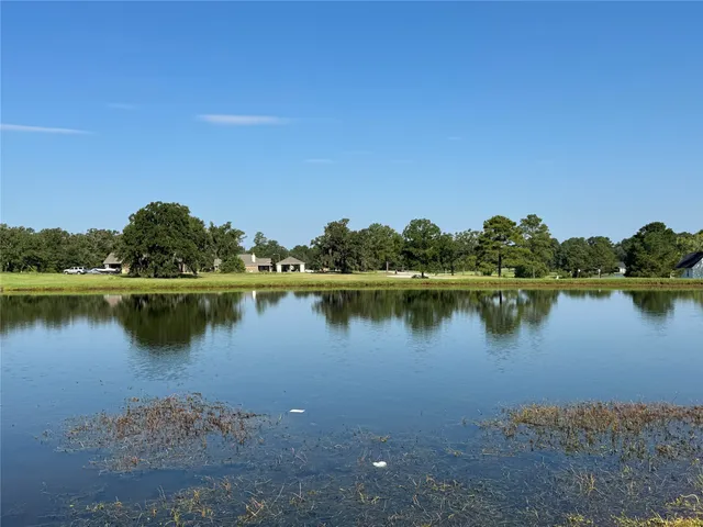 a view of a lake with houses in the background
