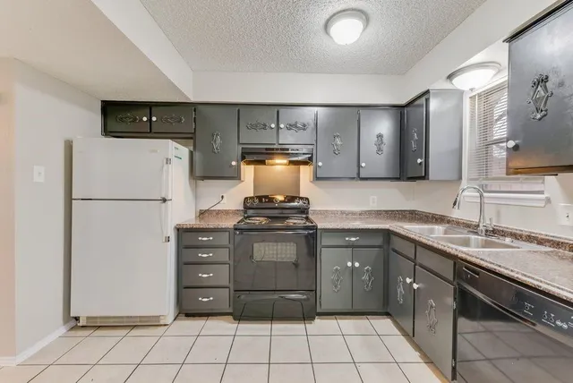 a spacious bathroom with a granite countertop sink and a mirror