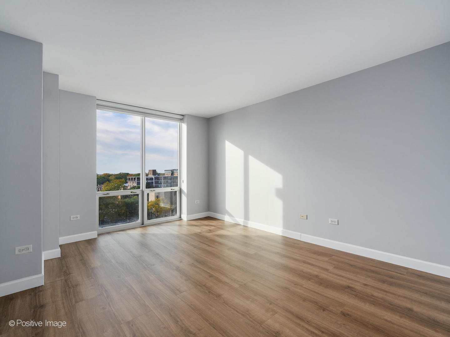 1640 Maple Avenue, Unit 804 Evanston, IL 60201 - Photo 12 of 27 a view of an empty room with wooden floor and a window