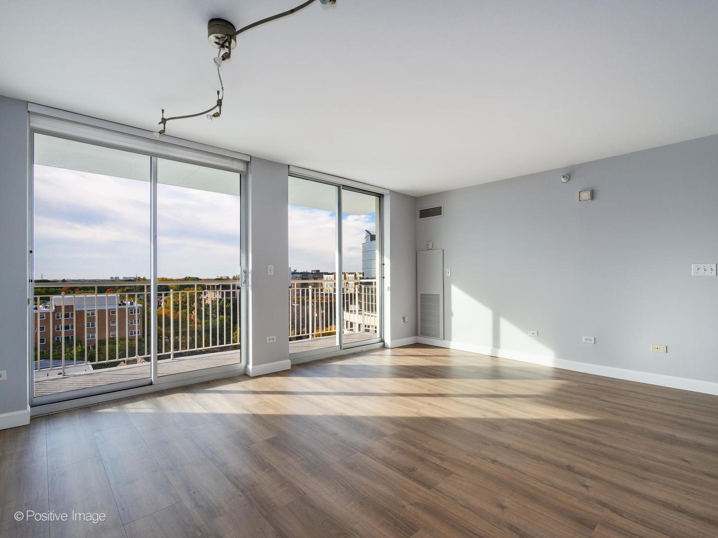 1640 Maple Avenue, Unit 804 Evanston, IL 60201 - Photo 6 of 27 a view of an empty room with wooden floor and a window