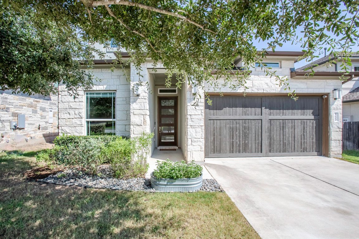 a front view of a house with garden
