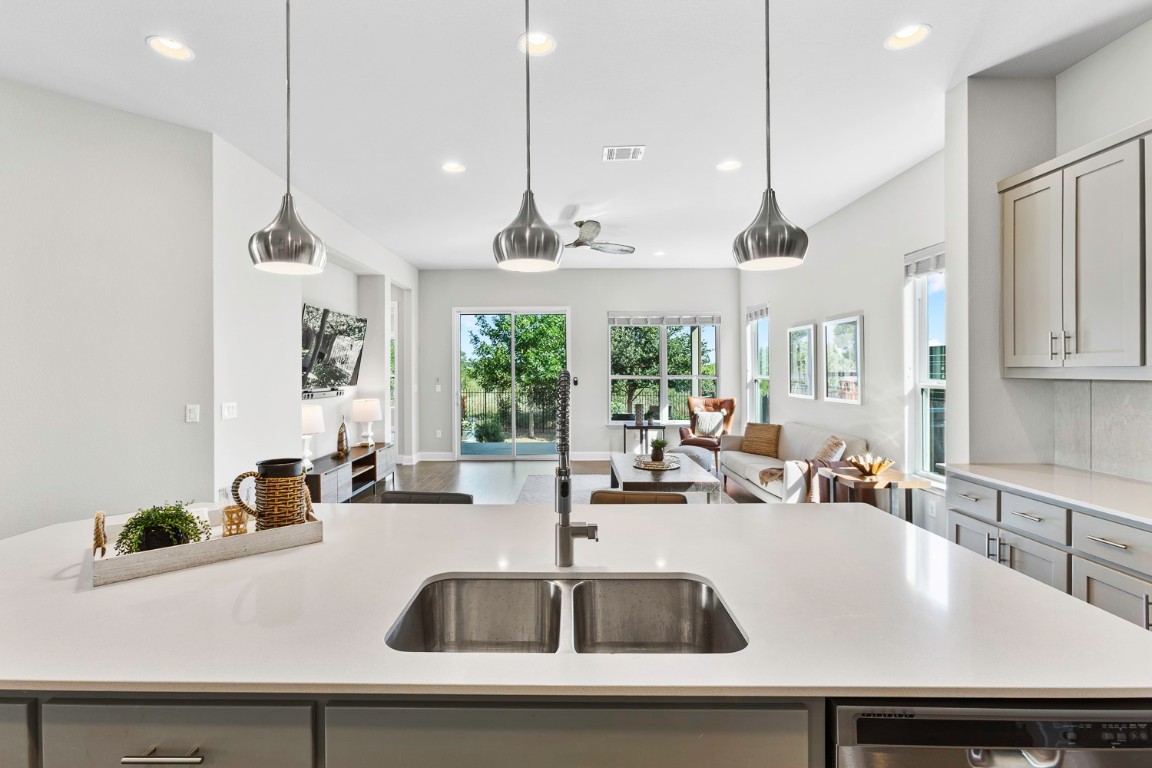 5000 Mandevilla Drive Austin, TX 78739 - Photo 11 of 40 a kitchen with a sink a counter space a large window and stainless steel appliances