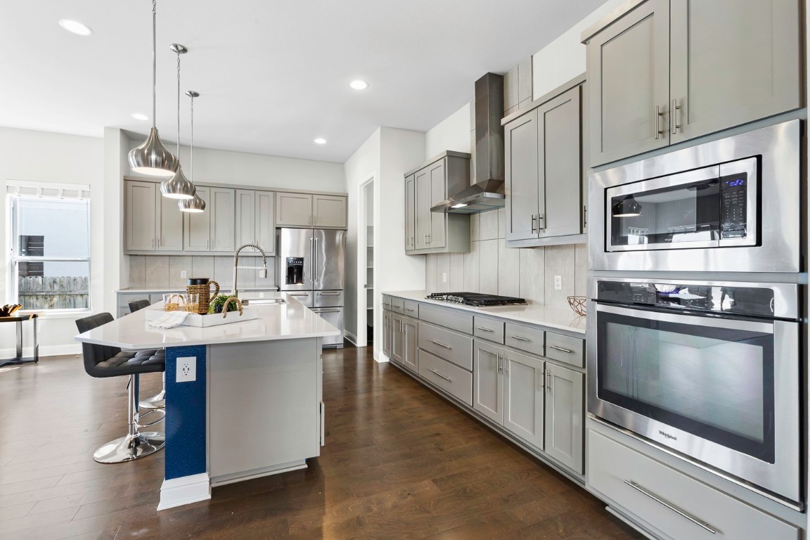 5000 Mandevilla Drive Austin, TX 78739 - Photo 13 of 40 a kitchen with kitchen island stainless steel appliances a stove center island a cabinets and a center island