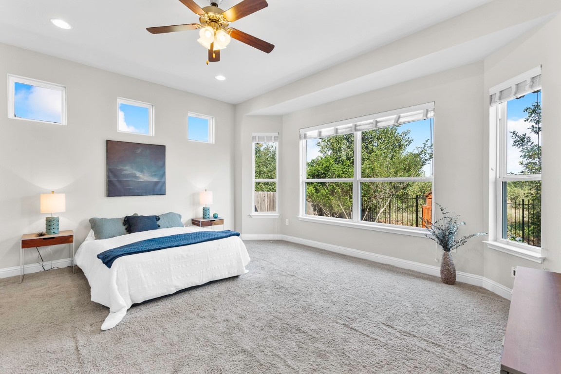 5000 Mandevilla Drive Austin, TX 78739 - Photo 15 of 40 a spacious bedroom with a large bed and a window