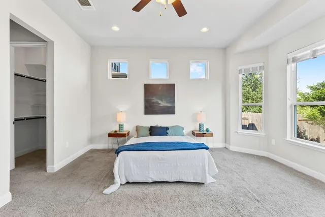 a bedroom with a large bed and a chandelier