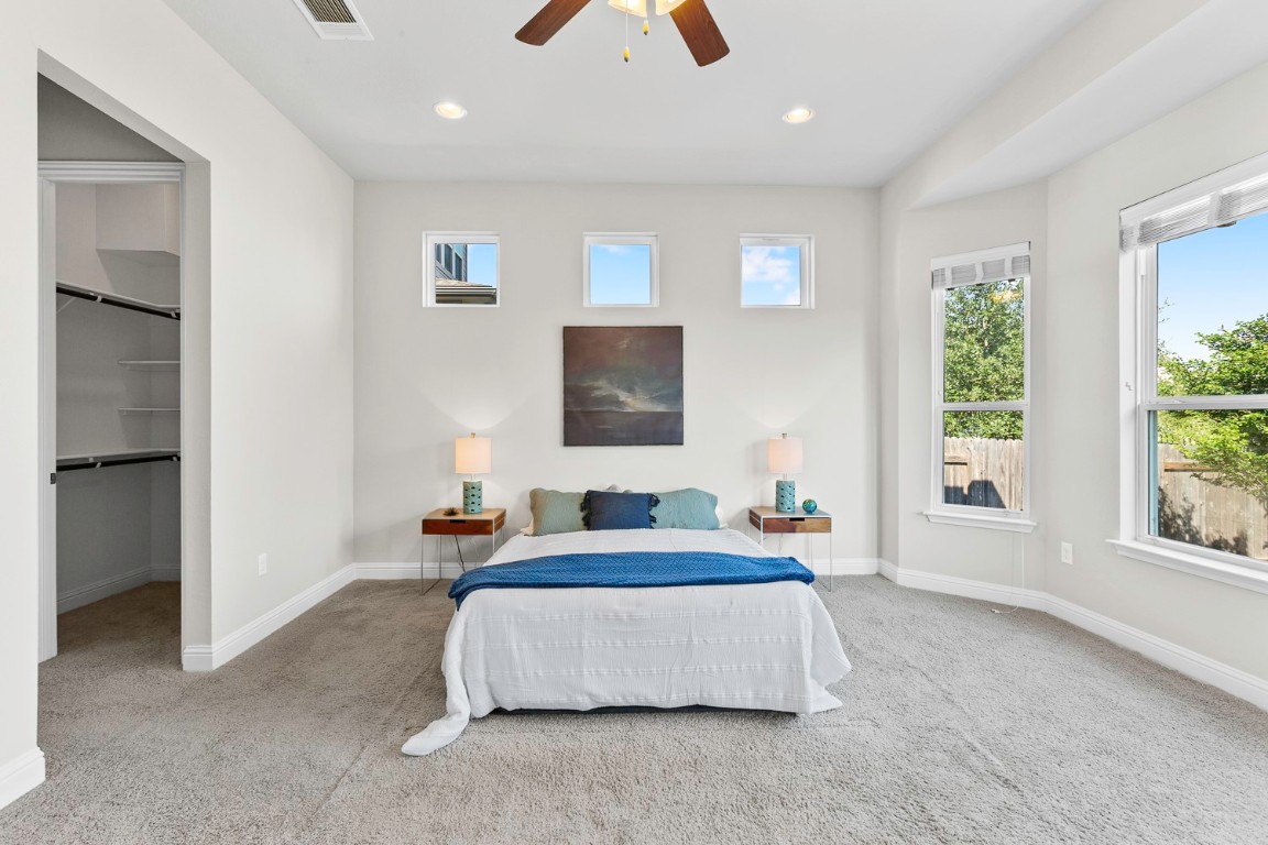 5000 Mandevilla Drive Austin, TX 78739 - Photo 16 of 40 a bedroom with a large bed and a chandelier