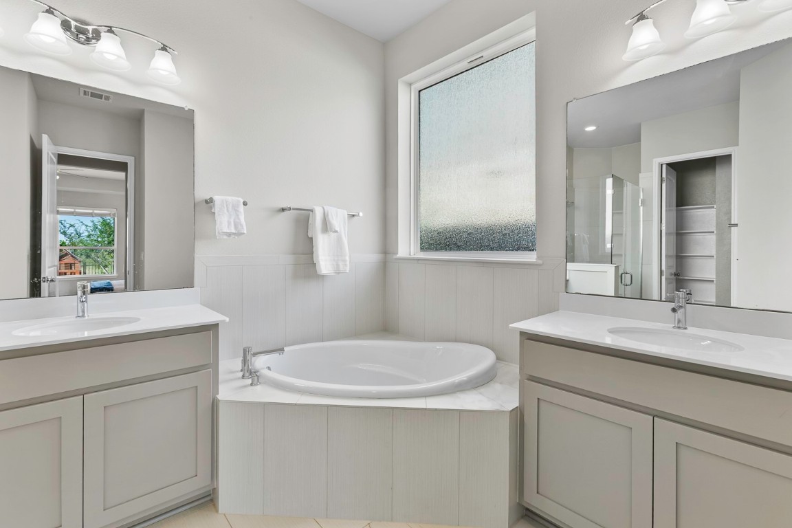 5000 Mandevilla Drive Austin, TX 78739 - Photo 18 of 40 a bathroom with a toilet sink and mirror