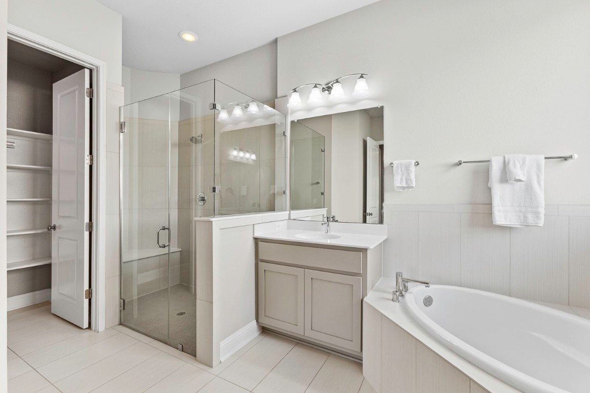 5000 Mandevilla Drive Austin, TX 78739 - Photo 19 of 40 a bathroom with a double vanity sink mirror and shower