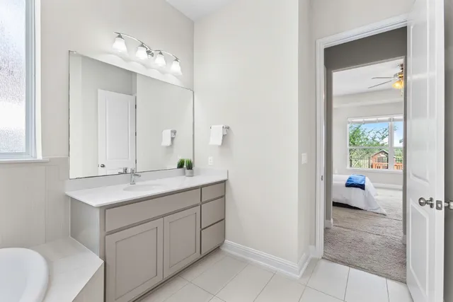 a en suite bathroom with a sink a mirror and a shower