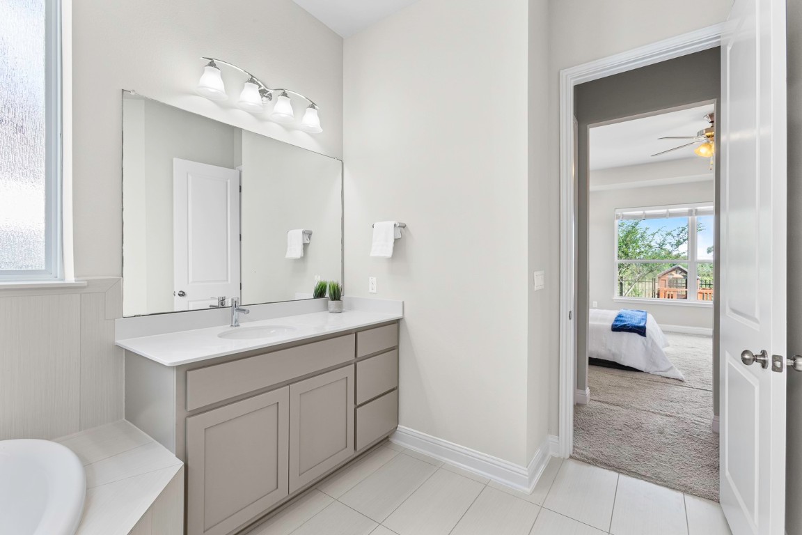 5000 Mandevilla Drive Austin, TX 78739 - Photo 20 of 40 a en suite bathroom with a sink a mirror and a shower
