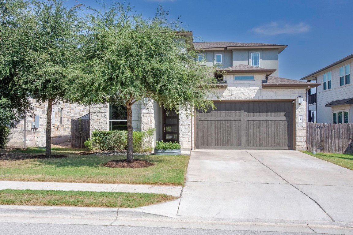 5000 Mandevilla Drive Austin, TX 78739 - Photo 2 of 40 a front view of a house with a yard and garage