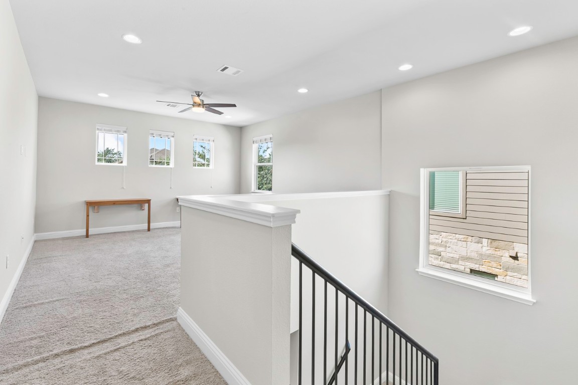 5000 Mandevilla Drive Austin, TX 78739 - Photo 30 of 40 a view of a hallway with furniture and a chandelier