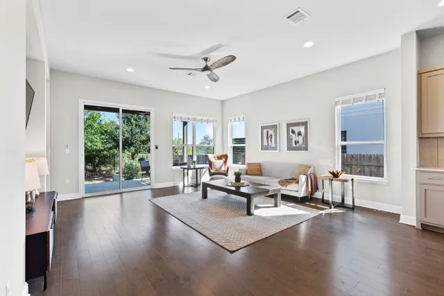a living room with furniture and wooden floor