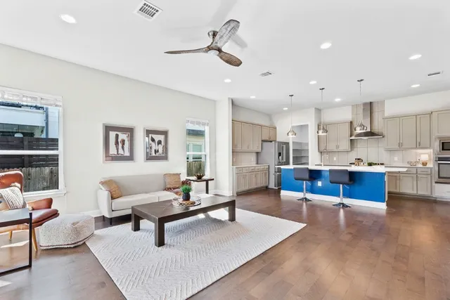 a living room with furniture and kitchen view