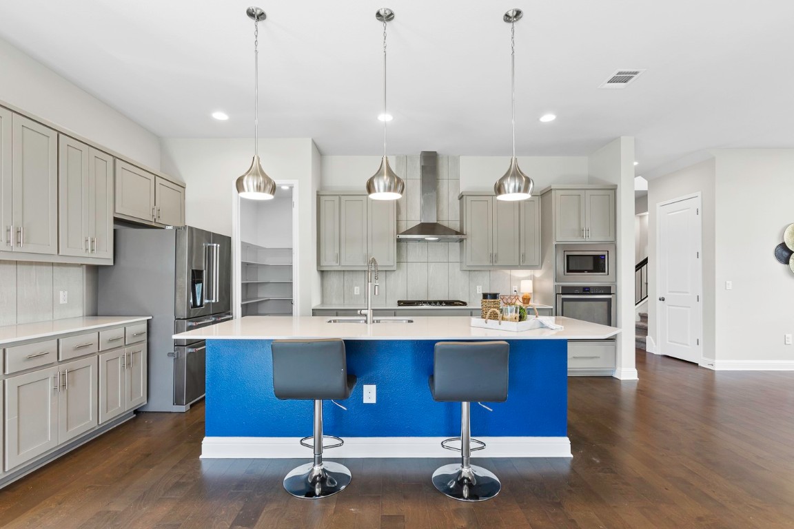 5000 Mandevilla Drive Austin, TX 78739 - Photo 9 of 40 a kitchen with a sink a center island stainless steel appliances and cabinets