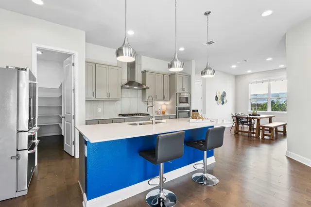 a large kitchen with a table and chairs