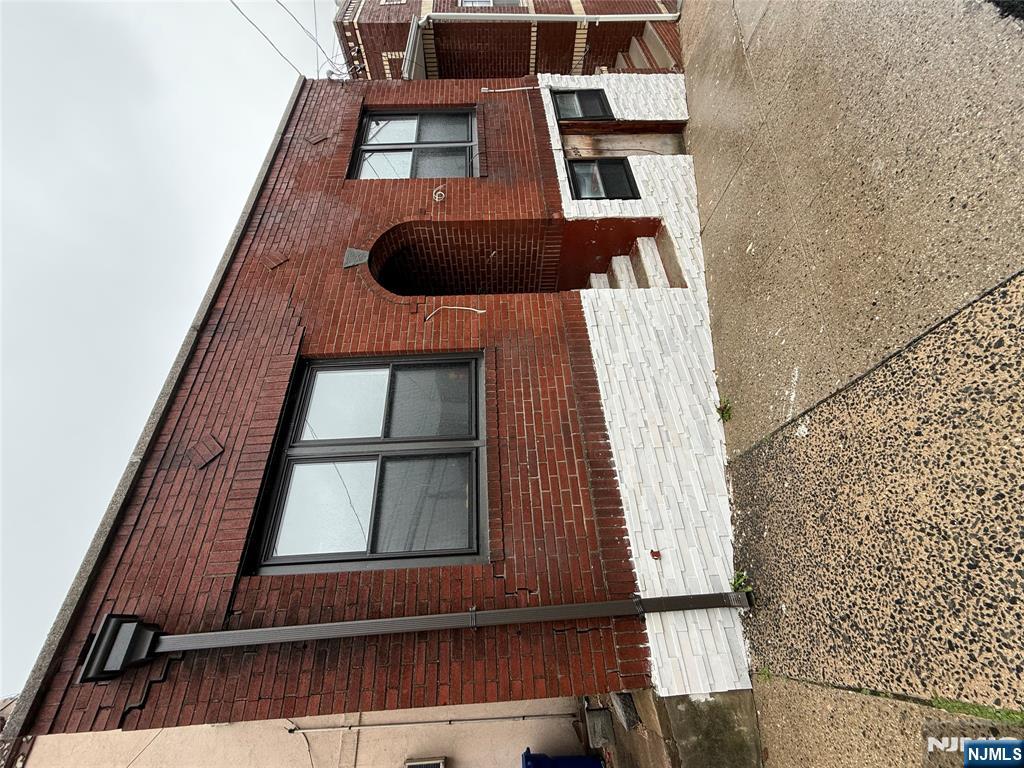 a view of a house with large windows