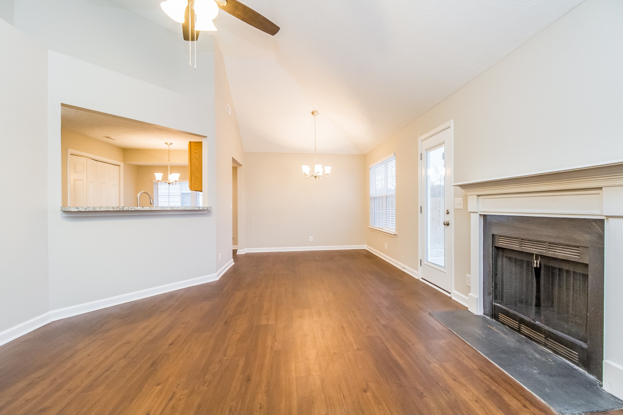 Undisclosed Address Antioch, TN 37013 - Photo 2 of 17 an empty room with wooden floor fireplace and windows